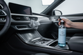 Interior detailer spray cleaning car dashboard